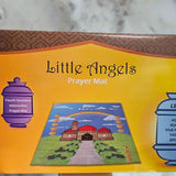 Box of 'Little Angels Prayer Mat' with colourful design and text on a marble surface.