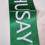 Green sash with 'HUSAYNI' printed in white on a white background
