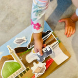Child playing with Prophet Muhammad puzzle on a beige carpet