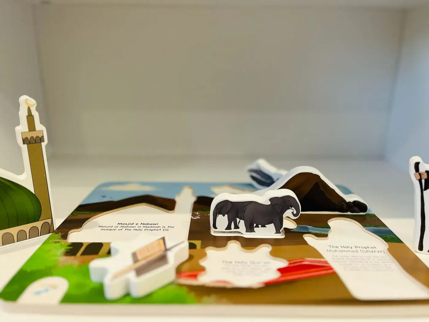 Pop-up book with animal illustrations on a plain background