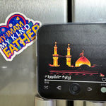 Phone with a dua ziyarat fridge magnet audio on a metallic surface next to a colorful sticker.