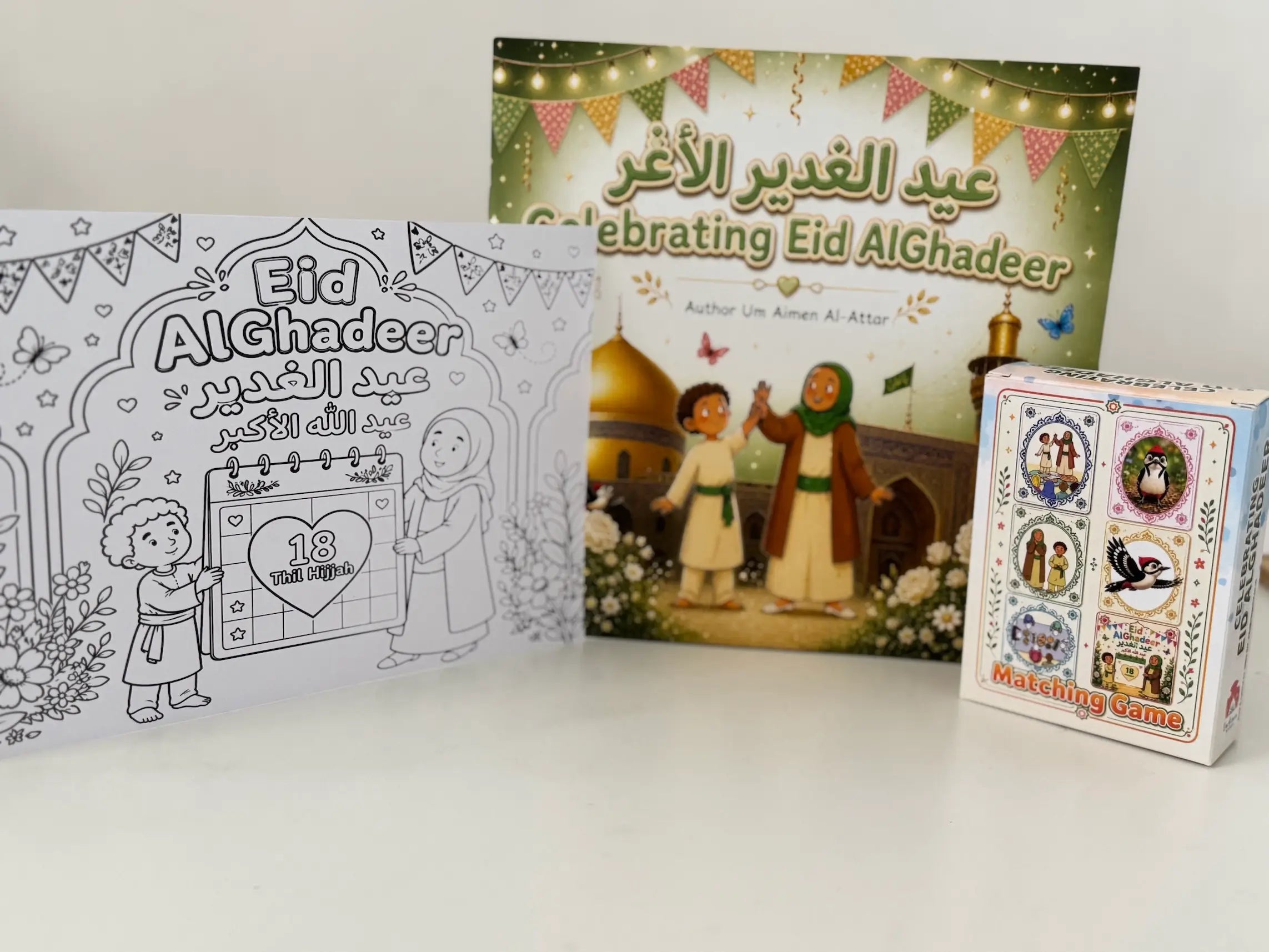 Eid Al Ghadeer themed products including a colouring sheet, a picture book, and a matching game on a white background.