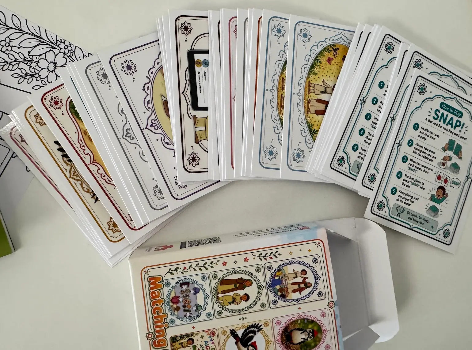 Collection of snap and memory match game cards with various designs on a white surface
