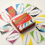 A box of Fatimy Cards surrounded by scattered colorful cards on a plain light background. The box is red with multicolored graphics and the text 'FATIMY CARDS' prominently visible.
