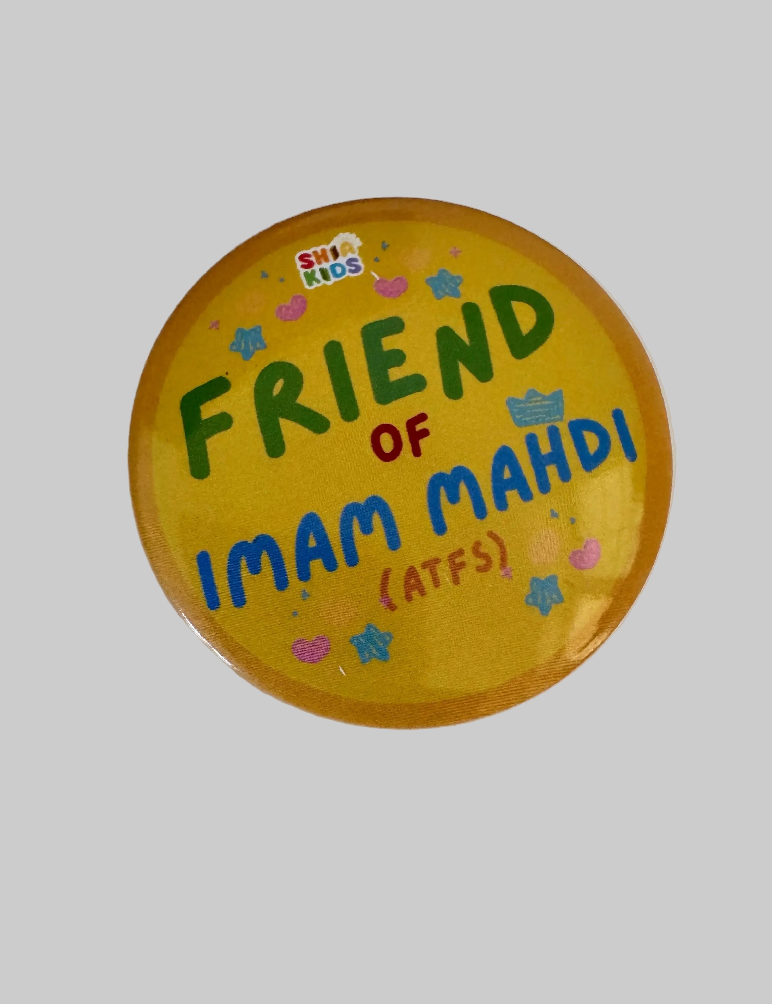 A round yellow button badge with colorful text reading 'FRIEND OF IMAM MAHDI (ATFS)' and a small 'SHIA KIDS' logo, photographed on a white surface.