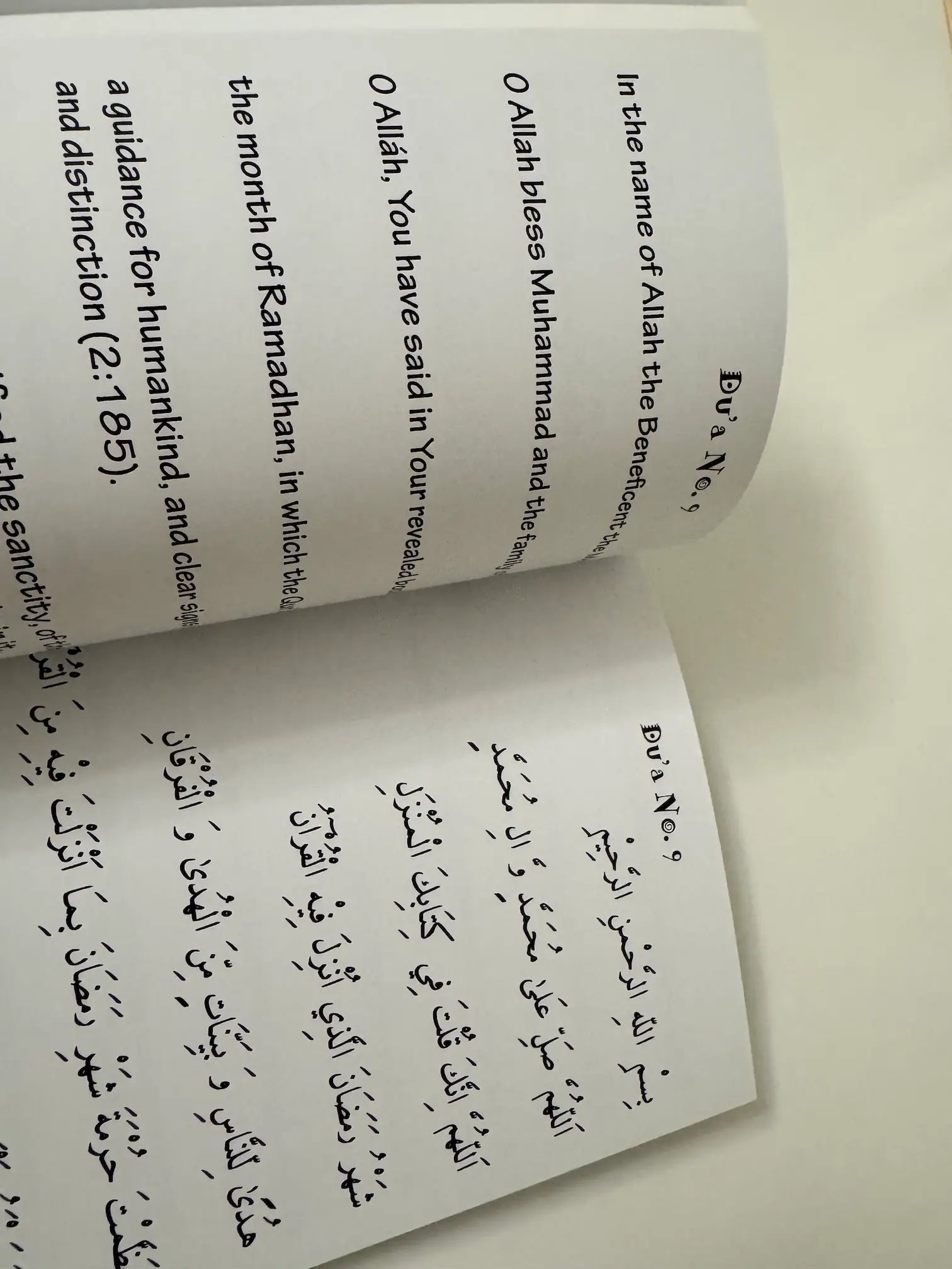 Open book with Arabic text on a white background