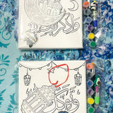 Canvas with illustrations and coloring supplies on a blue patterned background