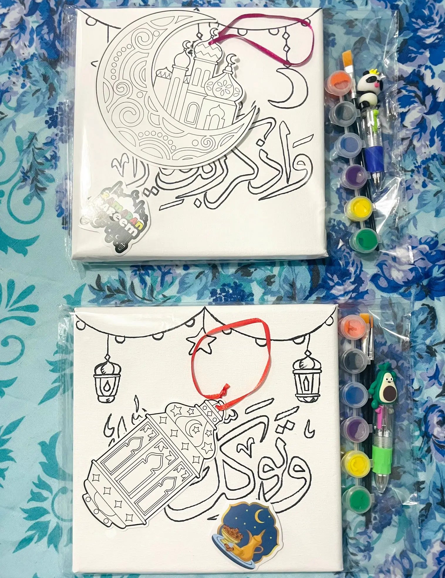 Canvas with illustrations and coloring supplies on a blue patterned background