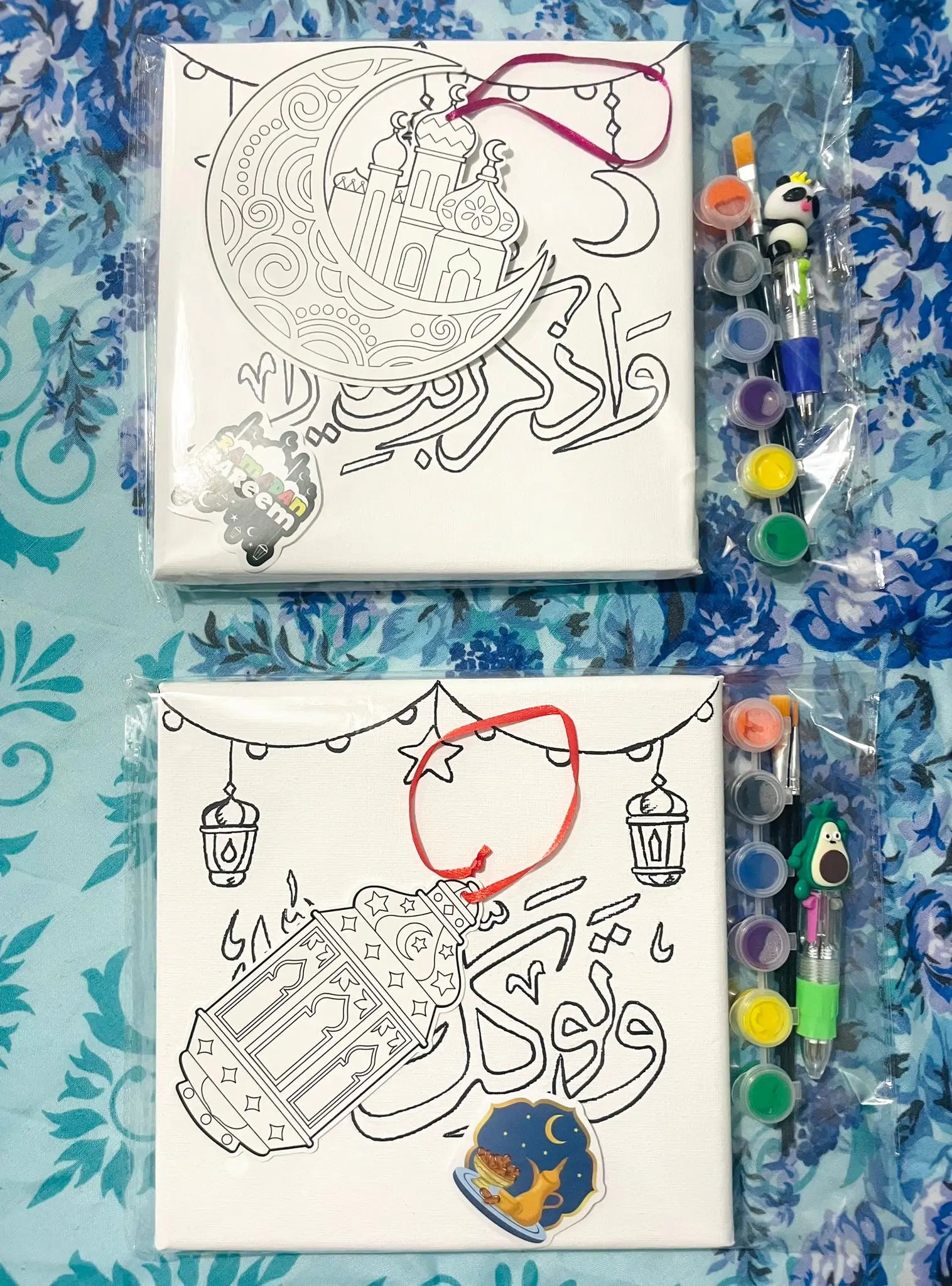 Canvas with illustrations and coloring supplies on a blue patterned background