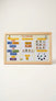 A wooden-framed 'My Calendar' magnetic board with colorful calendar tiles, event stickers, activity icons, and a moon phase tracker, photographed against a clean off-white background.