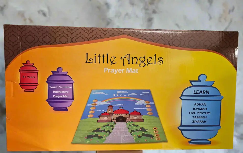 Box of 'Little Angels Prayer Mat' with colourful design and text on a marble surface.