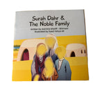 Book titled 'Surah Dahr & The Noble Family' on a wooden surface