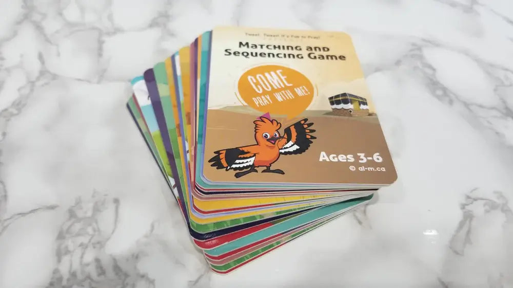 Stack of colorful children's cards on a marble surface