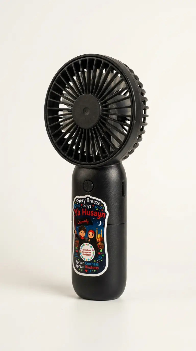 A black handheld personal fan with a circular fan head and a cylindrical body, featuring a colorful printed label on the front, photographed against a plain white background.