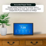 Ahlbyt Portal showing prayer times on a wooden table with a plant in the background