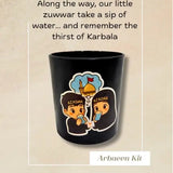 Black mug with child characters drinking from a cup and remembering Karbala and text on a beige background, featuring the brand 'ABABEL'.
