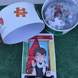 Puzzle pieces in a container, a card with a character illustration, and a box labeled '700 pieces' on a green surface.