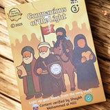 Two cards from 'Companions of the Light' game on a wooden surface with decorative elements.