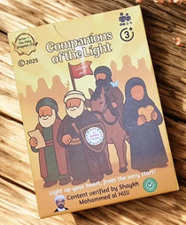 Two cards from 'Companions of the Light' game on a wooden surface with decorative elements.