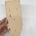 Wooden puzzle piece held by a hand on a white background