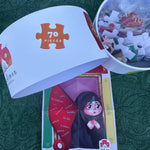 Jigsaw puzzle set with packaging on a green surface