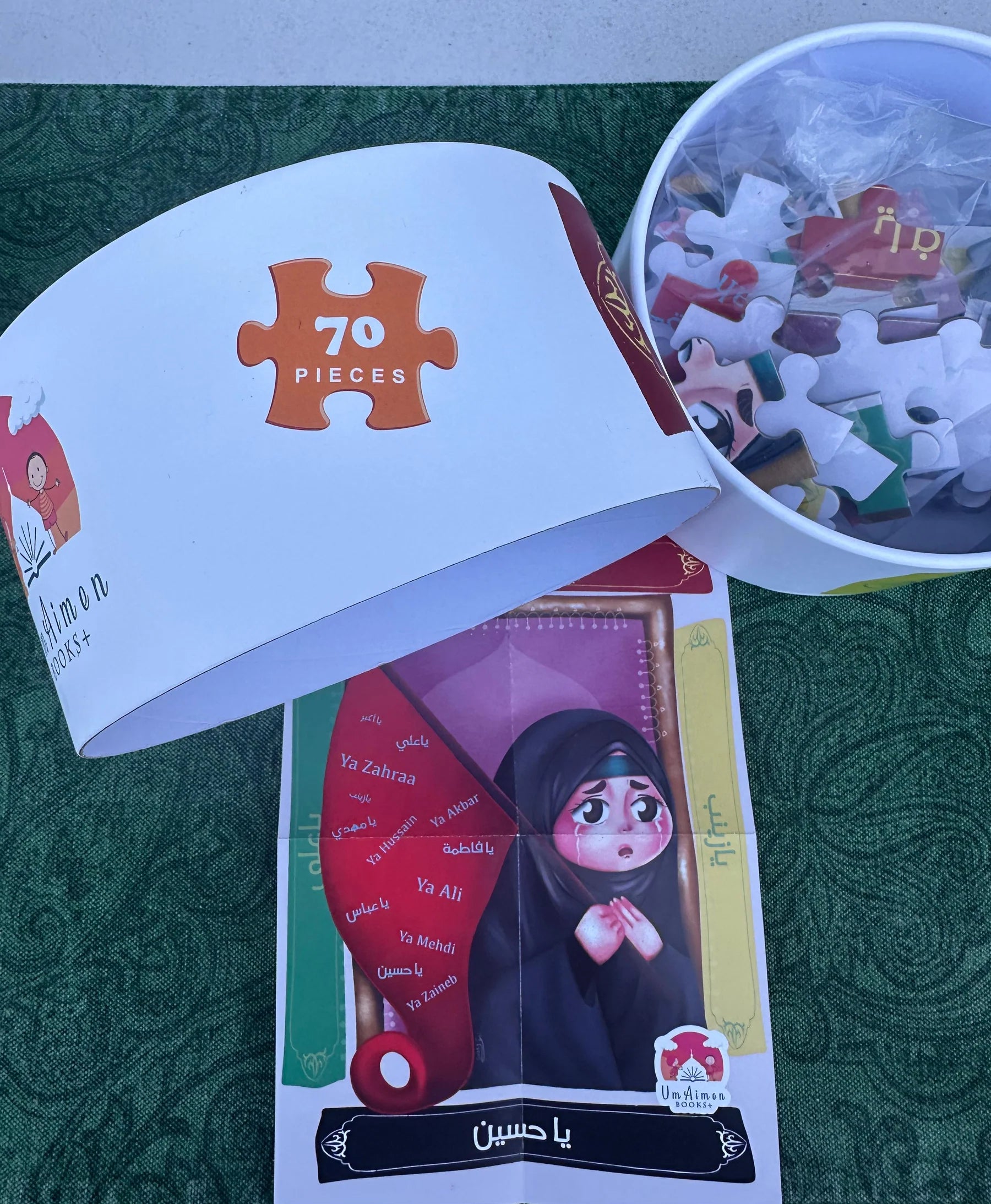 Jigsaw puzzle set with packaging on a green surface