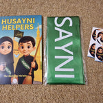 Book titled 'Husayni Helpers' with a green sash and stickers on a brown carpet.