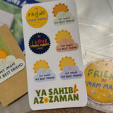 A collection of colourful stickers with various designs related to Imam Mahdi, displayed on a table.