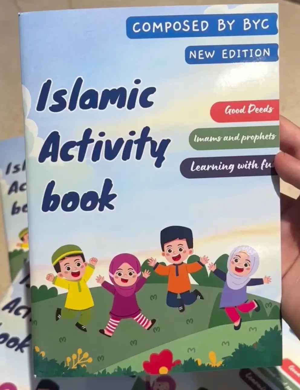 Children's book titled 'Islamic Activity Book' held by a hand.