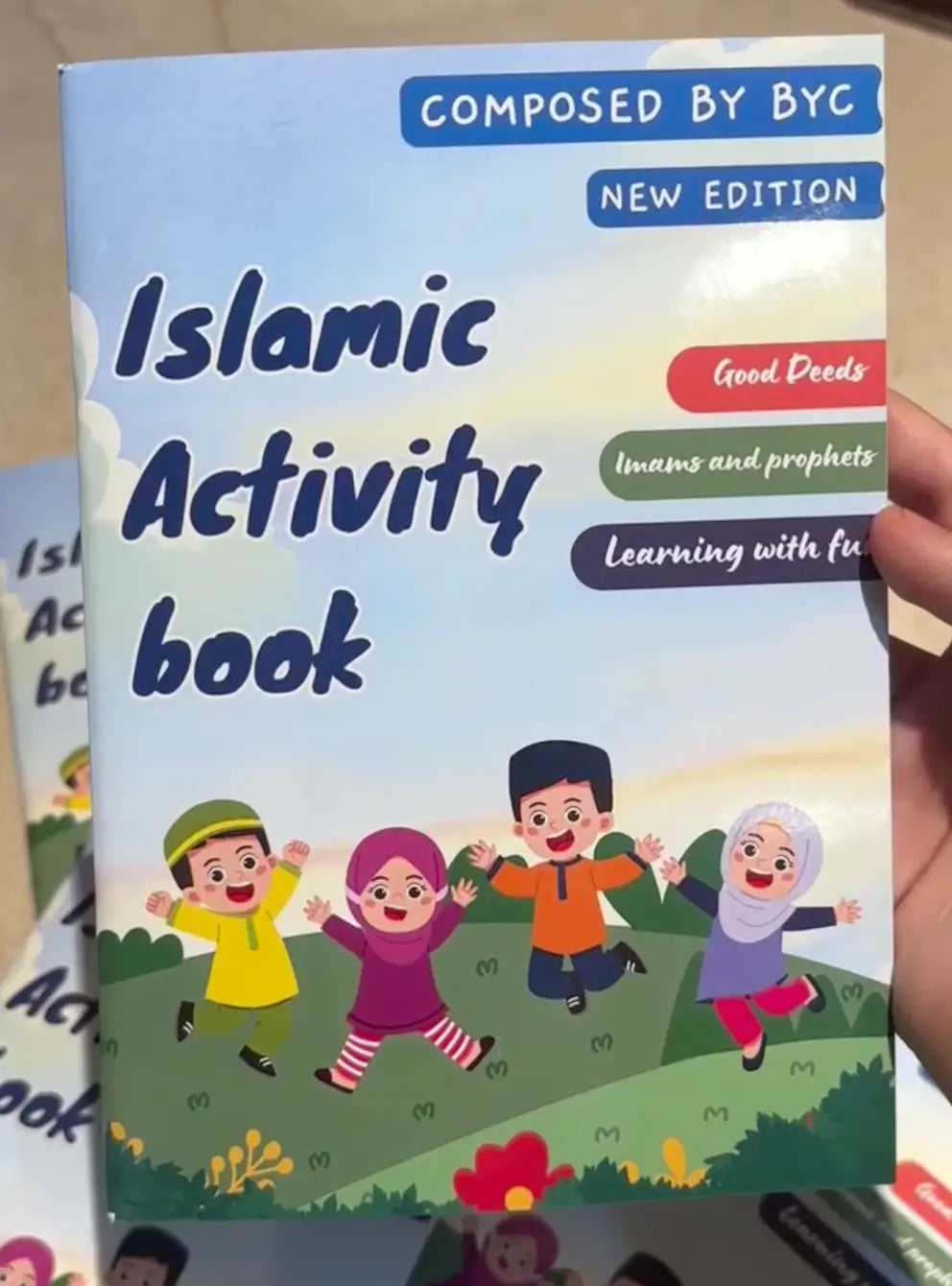 Children's book titled 'Islamic Activity Book' held by a hand.
