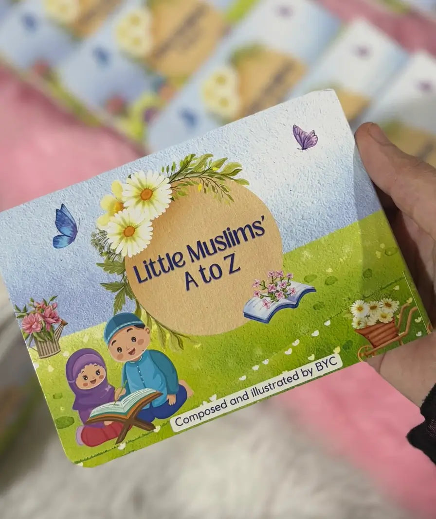 Children's educational book titled 'Little Muslims A to Z' held by a hand.