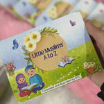 Children's educational book titled 'Little Muslims A to Z' held by a hand.