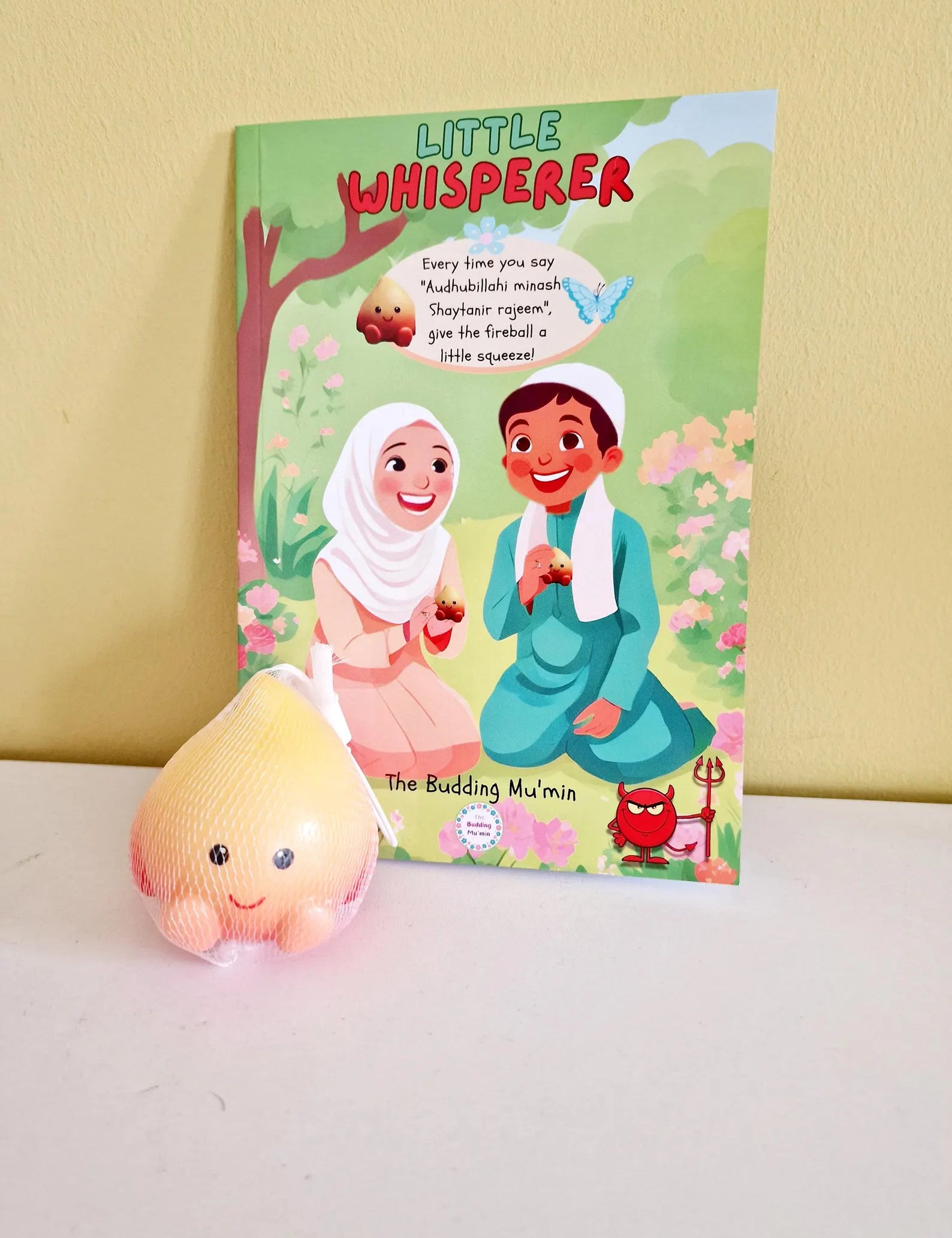 Children's book titled 'Little Whisperer' with free Squishy toy on a white surface.