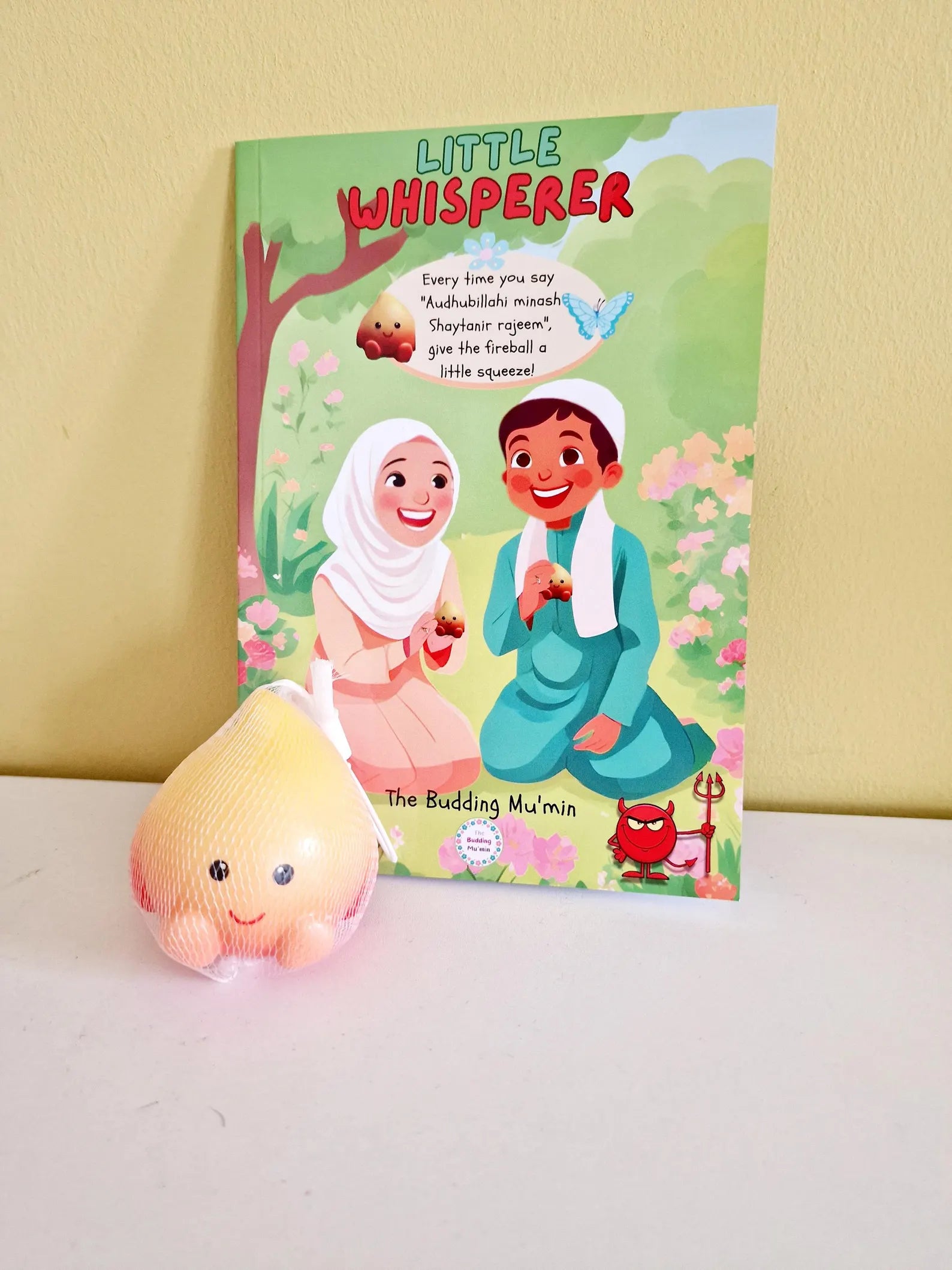 Children's book titled 'Little Whisperer' with free Squishy toy on a white surface.