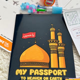Black book with mosque illustration and text on a surface with stationery items