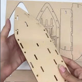 Wooden laser-cut puzzle piece held by hands with a detailed diagram in the background.