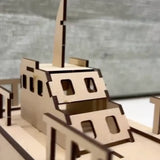 Wooden DIY model of a ship on a gray surface