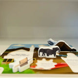 Pop-up book with animal illustrations on a plain background