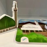 Educational toy puzzle by Kawthar kids with a mosque model and a book on a white surface