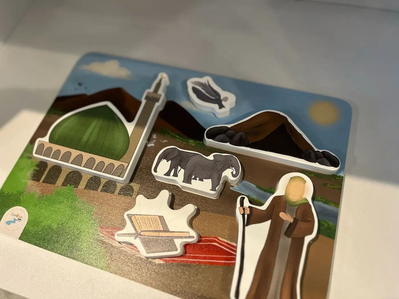 Holy Prophet Educational puzzle with cut-out pieces of a landscape and figures on a cardboard base. By Kawthar Kids