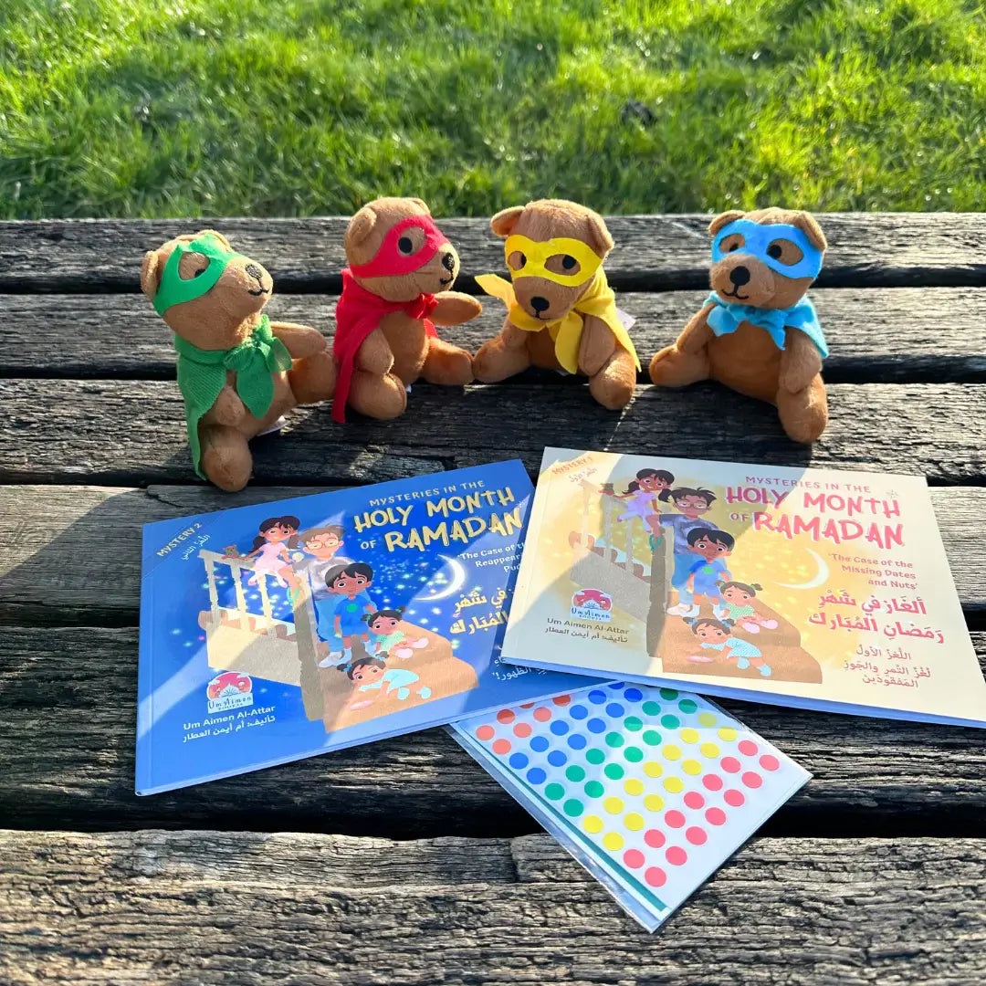 Four teddy bears with colorful masks and two books on a wooden surface with grass in the background. "Mysteries of the Holy Month of Ramadan" by UmAimenBooks