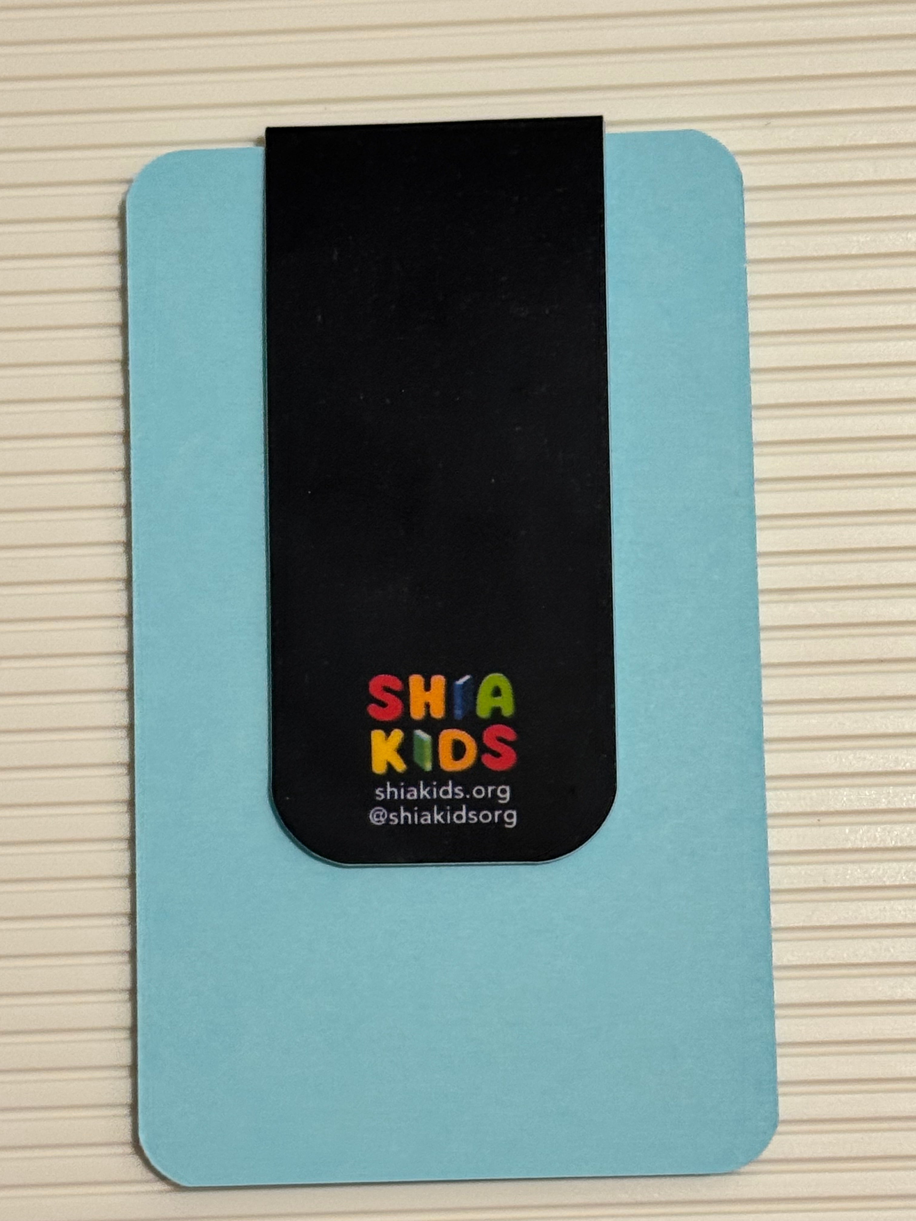Magnetic bookmark with colorful text on a light blue card against a striped background. Perfect Islamic gift
