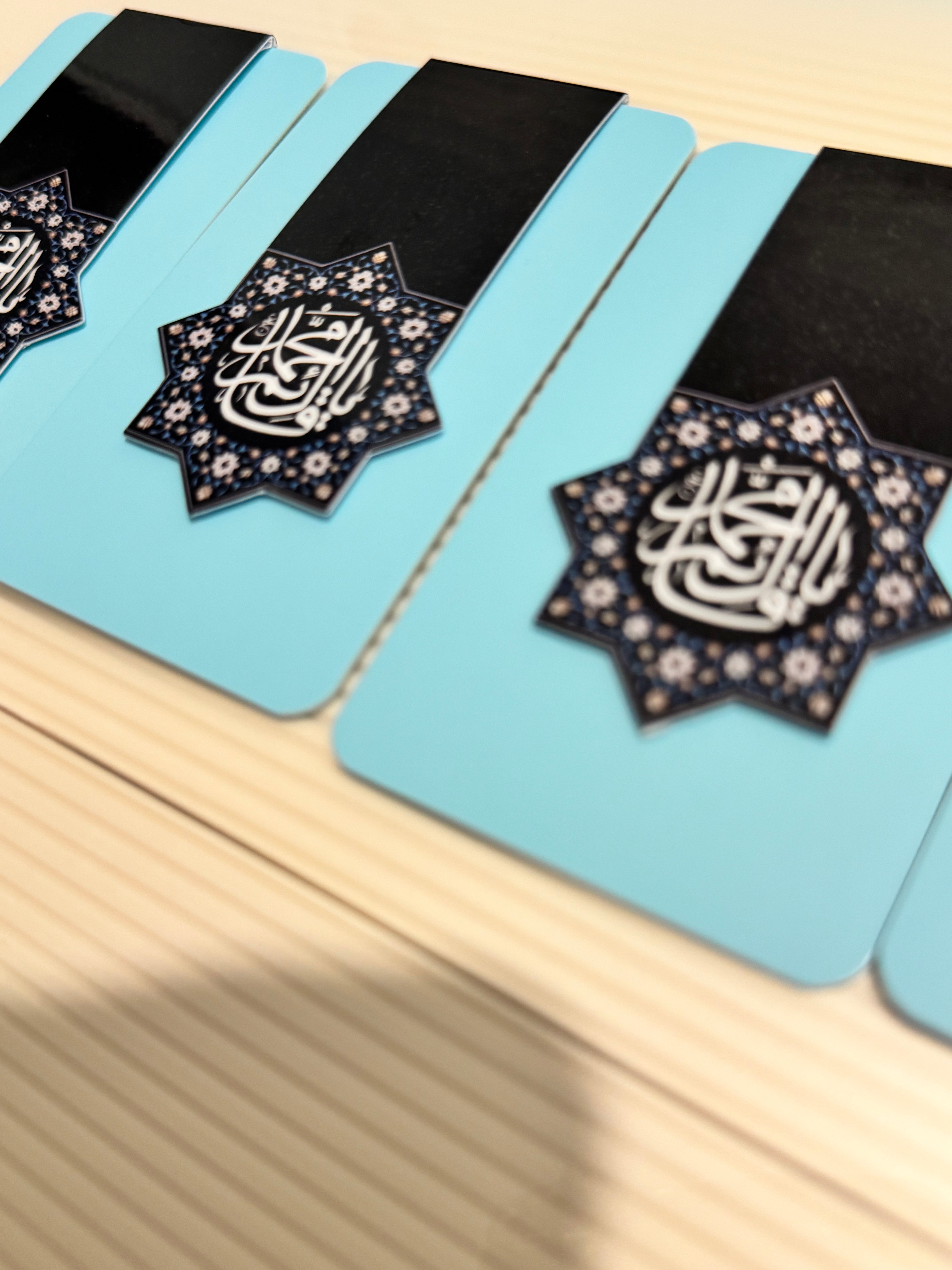 Decorative items with "Ya Qaim Aale Muhammad" calligraphy on a light blue background